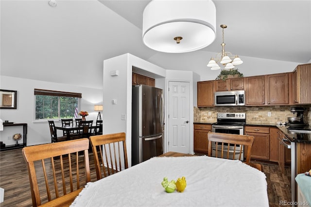 5337 S Ukraine Way, Aurora, CO 80015 - kitchen featuring stainless steel appliances, dark wood finished floors, decorative backsplash, dark countertops, and high vaulted ceiling