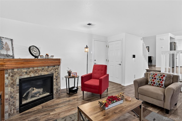 5337 S Ukraine Way, Aurora, CO 80015 - living room with wood finished floors, a glass covered fireplace, and stairs