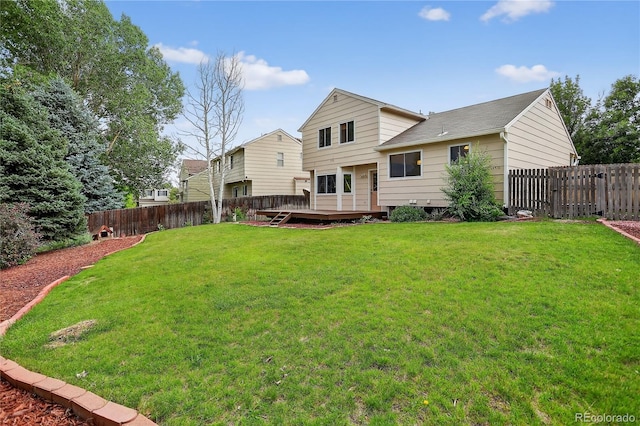 5337 S Ukraine Way, Aurora, CO 80015 - rear view of house featuring a fenced backyard, a wooden deck, and a shingled roof