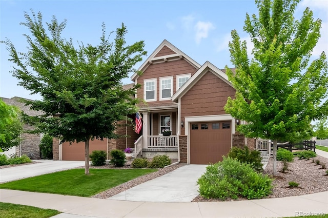 8782 S Wenatchee Ct, Aurora, CO 80016 - craftsman-style home with stone siding, a garage, concrete driveway, and a porch