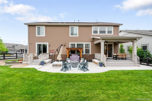 8782 S Wenatchee Ct, Aurora, CO 80016 - rear view of house featuring a patio area, roof mounted solar panels, and a deck