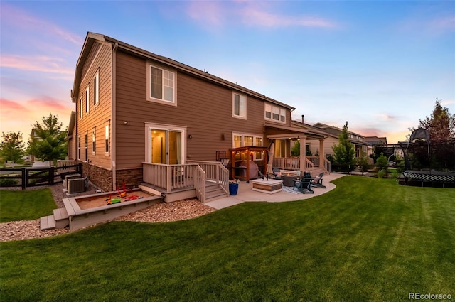 8782 S Wenatchee Ct, Aurora, CO 80016 - back of house at dusk featuring a patio and a wooden deck