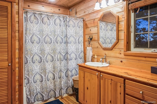 bathroom featuring wooden walls, vanity, wood ceiling, and hardwood / wood-style flooring