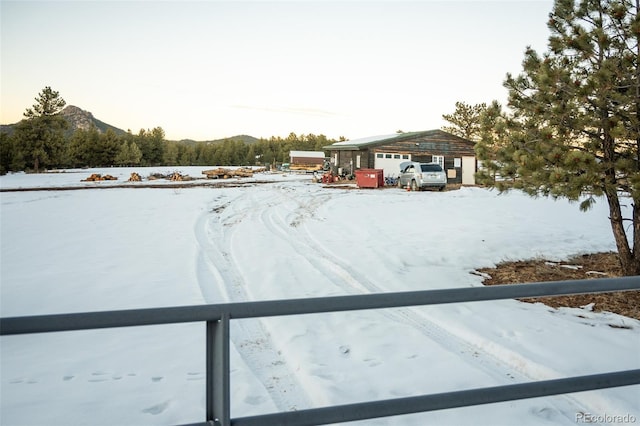 yard covered in snow with a mountain view