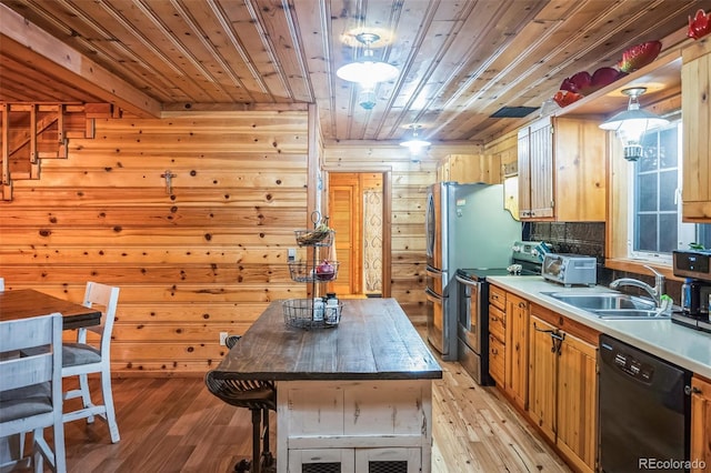 kitchen with dishwasher, light wood-type flooring, stainless steel range with electric cooktop, and wood walls