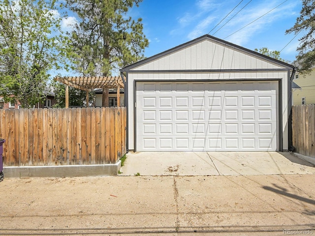 detached garage featuring fence