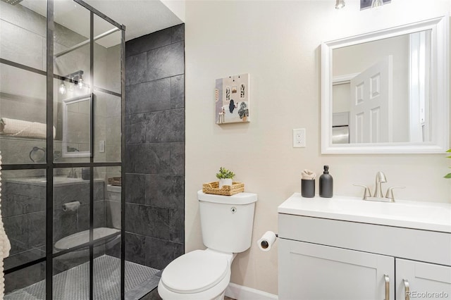 bathroom featuring vanity, toilet, and a tile shower