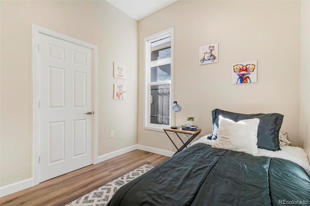 bedroom with wood-type flooring