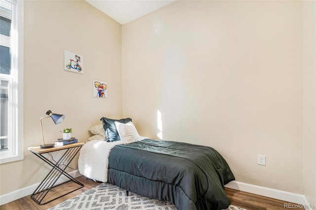 bedroom with hardwood / wood-style floors