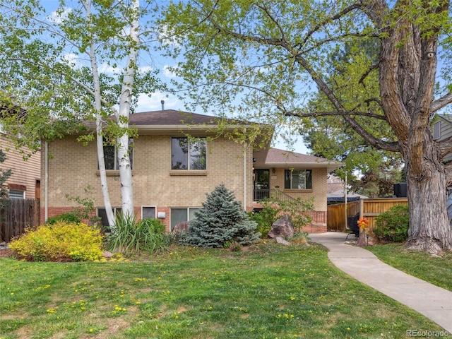 746 Birch St, Denver, CO 80220 - view of front of home with fence, a front yard, and brick siding