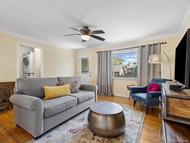 746 Birch St, Denver, CO 80220 - living room with crown molding, stacked washer / drying machine, ceiling fan, and light wood-style floors