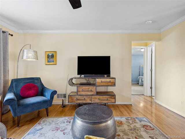 746 Birch St, Denver, CO 80220 - living area with baseboards, visible vents, ornamental molding, and wood finished floors