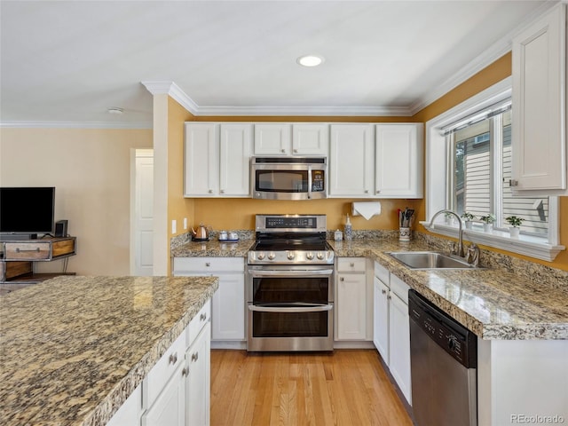 746 Birch St, Denver, CO 80220 - kitchen with crown molding, white cabinets, appliances with stainless steel finishes, a sink, and light wood finished floors