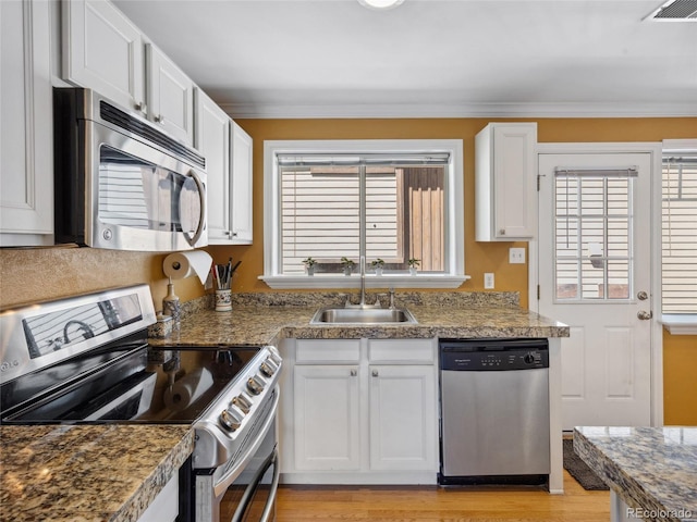 746 Birch St, Denver, CO 80220 - kitchen with a sink, appliances with stainless steel finishes, crown molding, and white cabinetry