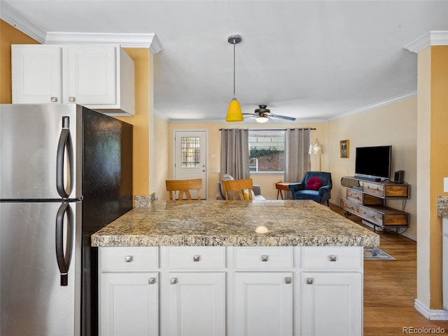 746 Birch St, Denver, CO 80220 - kitchen featuring crown molding, light wood-style floors, freestanding refrigerator, tile countertops, and a peninsula