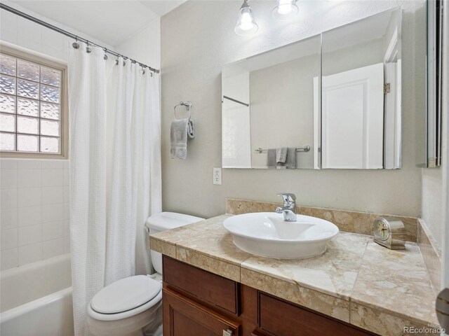 746 Birch St, Denver, CO 80220 - bathroom featuring vanity, shower / tub combo, and toilet