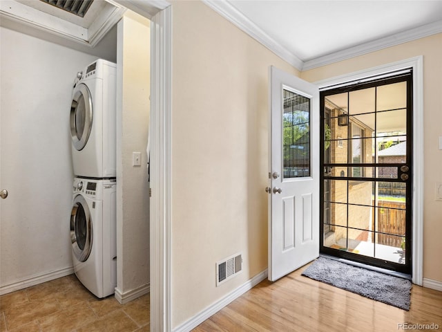 746 Birch St, Denver, CO 80220 - clothes washing area with stacked washer / drying machine, laundry area, baseboards, visible vents, and ornamental molding