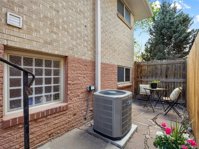 746 Birch St, Denver, CO 80220 - details with brick siding, fence, and cooling unit