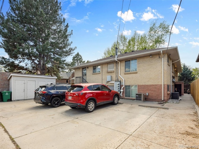 746 Birch St, Denver, CO 80220 - rear view of property featuring a storage unit, an outbuilding, central AC, and brick siding