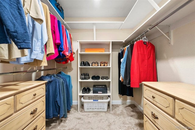 spacious closet featuring light colored carpet