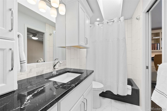 bathroom featuring ceiling fan, vanity, curtained shower, toilet, and backsplash