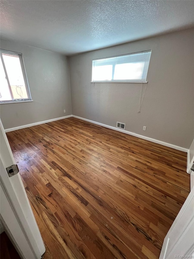 1245 Yates St, Denver, CO 80204 - unfurnished room with wood finished floors and a textured ceiling