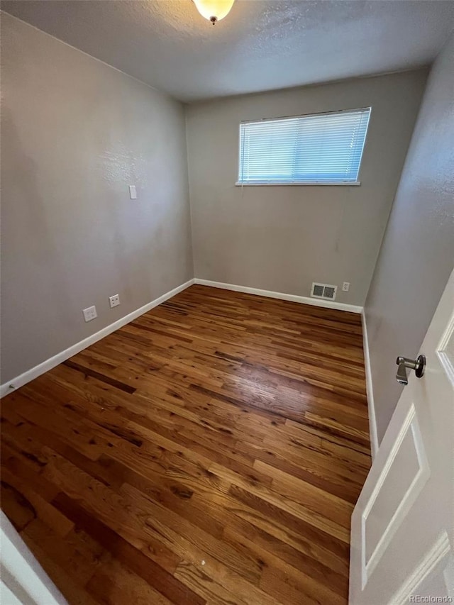1245 Yates St, Denver, CO 80204 - spare room featuring wood finished floors and a textured ceiling