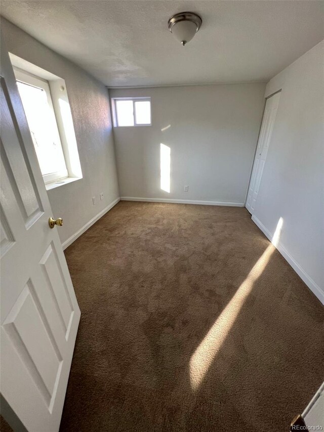 1245 Yates St, Denver, CO 80204 - empty room with carpet flooring and baseboards