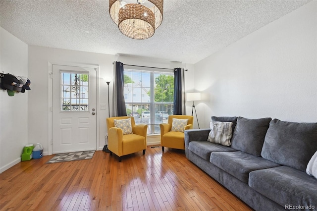 living room with light hardwood / wood-style flooring and a textured ceiling