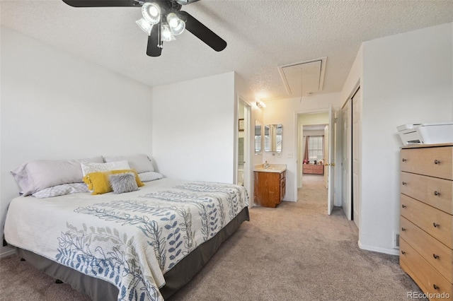 carpeted bedroom with connected bathroom, ceiling fan, and a textured ceiling