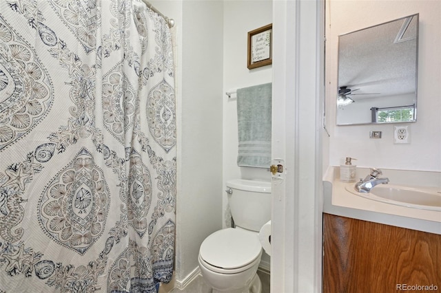 bathroom featuring vanity, ceiling fan, a textured ceiling, and toilet