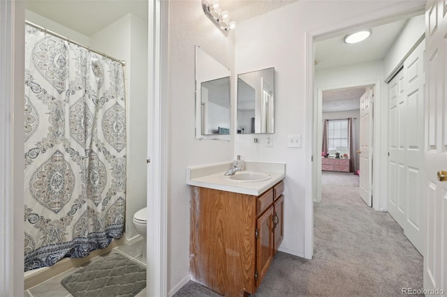 bathroom with vanity, a shower with shower curtain, and toilet