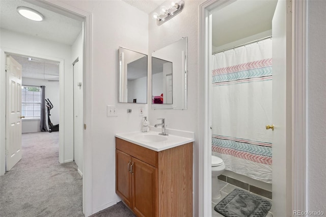 bathroom featuring vanity, walk in shower, a textured ceiling, and toilet