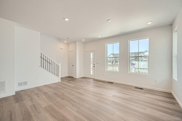 708 N Bently St, Watkins, CO 80137 - entryway with stairs, light wood-style floors, baseboards, recessed lighting, and a textured ceiling