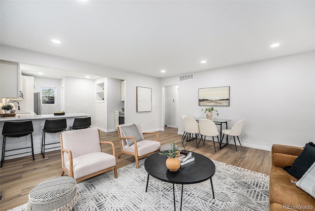 5491 Lowell Blvd, Denver, CO 80221 - living area featuring light wood-style flooring and recessed lighting