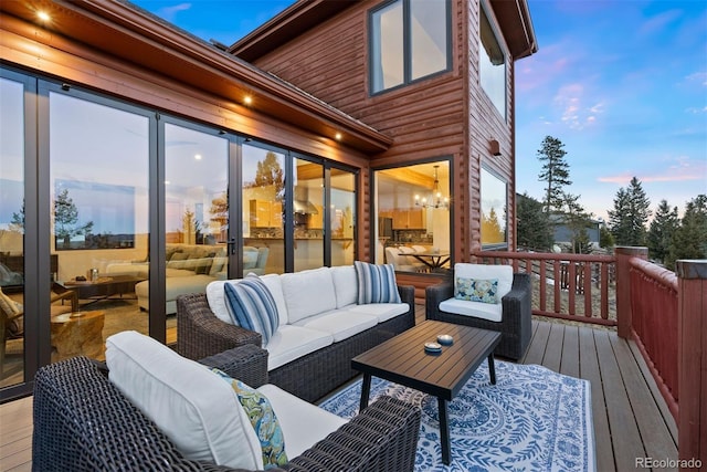 deck at dusk featuring outdoor lounge area