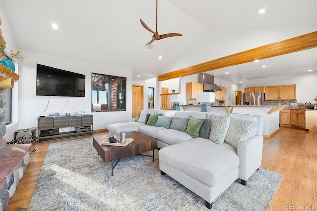 living room featuring high vaulted ceiling, recessed lighting, and light wood-style floors