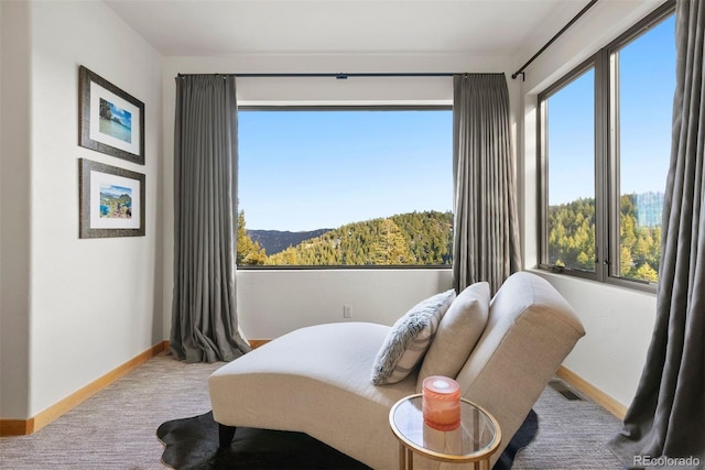 bedroom featuring baseboards, multiple windows, visible vents, and light colored carpet