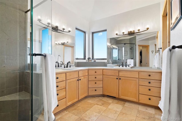 bathroom featuring double vanity, a sink, and a shower stall