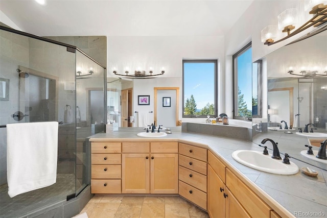 full bath with double vanity, a stall shower, and a sink