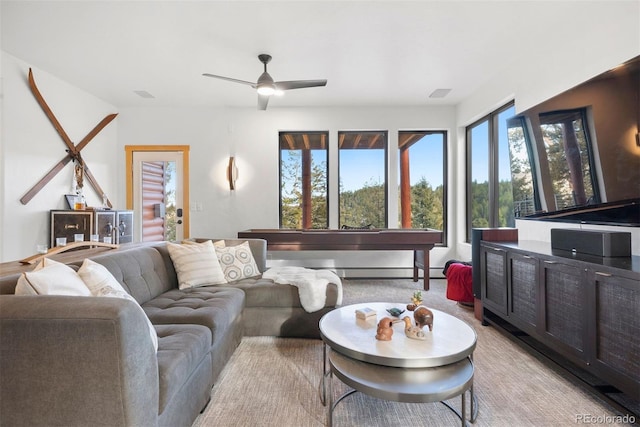 living area featuring visible vents and ceiling fan