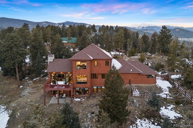 snowy aerial view with a mountain view