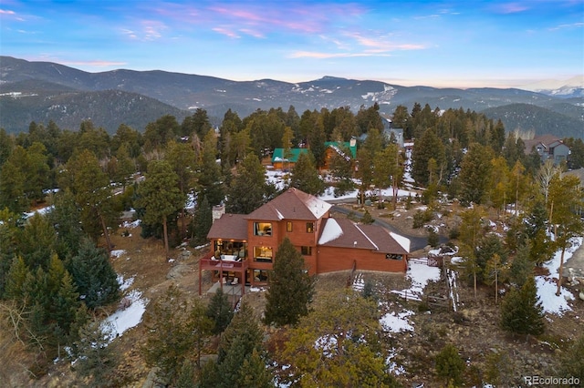 aerial view at dusk featuring a mountain view