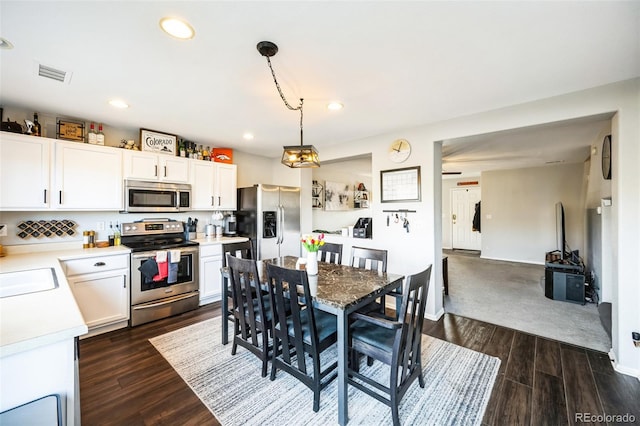 interior space with recessed lighting, visible vents, baseboards, and dark wood-type flooring