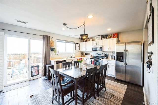 dining room featuring dark wood-style floors, visible vents, and recessed lighting