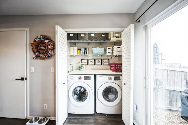 clothes washing area with dark wood finished floors, laundry area, and independent washer and dryer