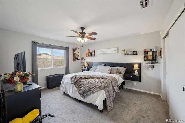 bedroom featuring a ceiling fan, baseboards, visible vents, a closet, and carpet flooring