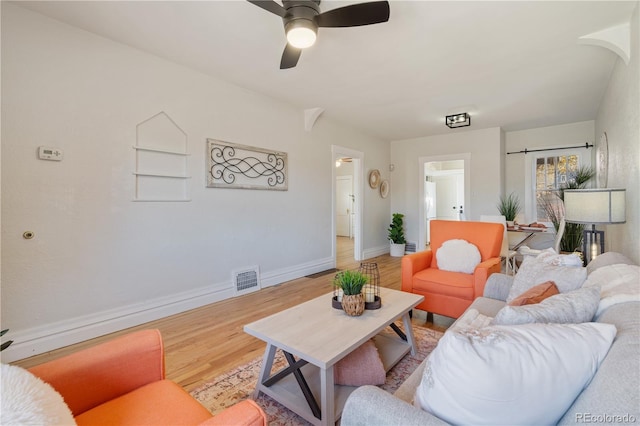 living room with ceiling fan and light wood-type flooring