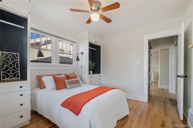 bedroom with ceiling fan and light hardwood / wood-style floors