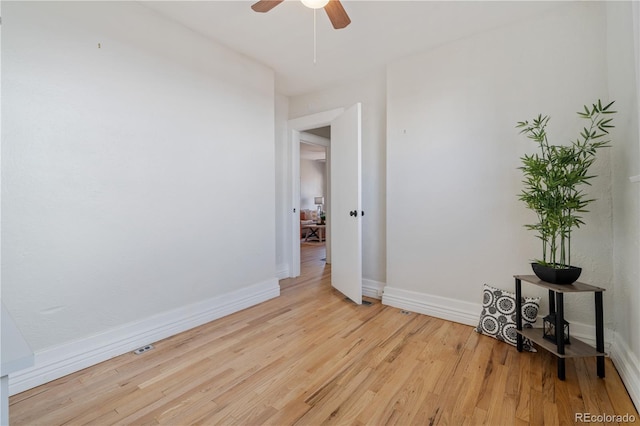 spare room featuring light hardwood / wood-style flooring and ceiling fan